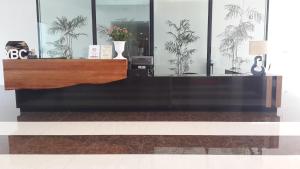 a desk in a room with plants on the wall at YBC Grand Hotel in Olongapo