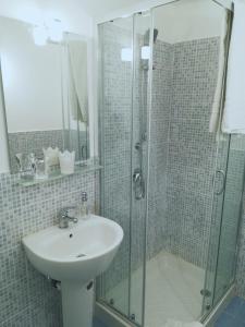 カターニアにあるLuxurious Street Apartmentsのバスルーム(洗面台、ガラス張りのシャワー付)
