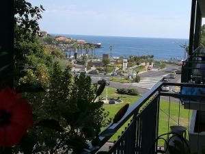 a balcony with a view of a street and the ocean at Luxurious Street Apartments in Catania