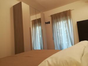 a bedroom with a bed and a mirror at Luxurious Street Apartments in Catania