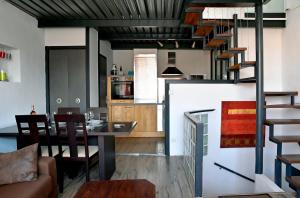 a kitchen and a living room with a spiral staircase at Le Panier - Joli duplex Centre ville historique avec grande terrasse et balnéo proche Vieux Port in Marseille