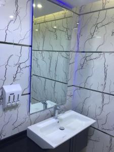 a bathroom with a sink and a mirror at Apartment at Milsa Nasr City, Building No. 21 in Cairo