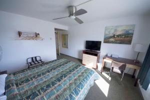 a bedroom with a bed and a flat screen tv at Rewak Studios in Fairbanks