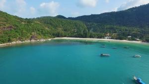 an aerial view of a beach with boats in the water at Longtail Beach Resort in Thong Nai Pan Yai