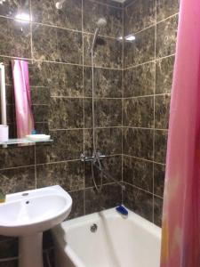 a bathroom with a shower and a sink and a tub at Apartments on Kirova 16 in Simferopol