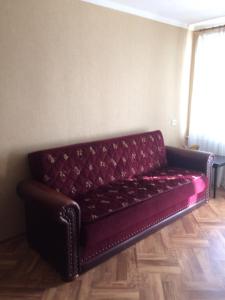 a leather couch sitting in a room at Apartments on Kirova 16 in Simferopol