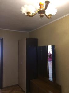 a ceiling fan and a mirror in a room at Apartments on Kirova 16 in Simferopol