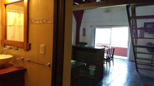 a bathroom with a sink and a table in a room at Jucaso Departamentos in San Pedro +74 photos
