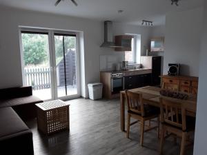 a kitchen with a table and chairs and a dining room at Pöhl am Nationalpark Eifel in Schleiden