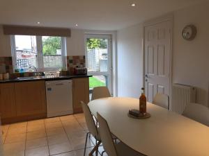 a kitchen and dining room with a table and chairs at March Cottage Brecon in Brecon