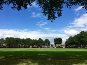 a green field with trees and a blue sky at Rochester Apartment in London