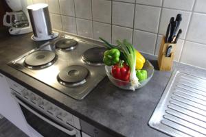 a bowl of vegetables sitting on a stove in a kitchen at Appartement Ewald Siller in Neustift im Stubaital