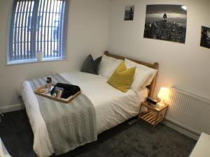 a bedroom with a bed with a tray on it at Parsons Street in Dudley