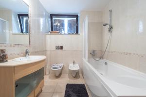 a bathroom with a tub and a toilet and a sink at Gorgeous apartment Dora in Cavtat +65 photos