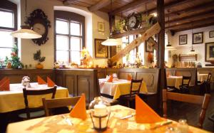 a restaurant with tables and chairs and clocks on the wall at Zum Fehmelbauer in Karlstadt