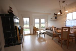 a living room with a couch and a table at Ferienpark An der Seebrücke in Ostseebad Koserow