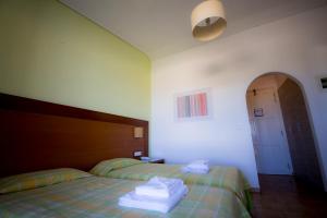 Postel nebo postele na pokoji v ubytování Hotel Navarone