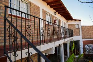a balcony of a house with wrought iron railing at El Viejo Molino in Chilecito
