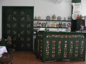a room with a green cabinet with a bar in it at Góbé Csárda in Oradea