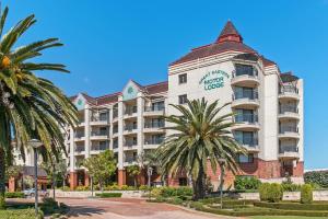 a hotel with palm trees in front of it at Great Eastern Motor Lodge in Perth