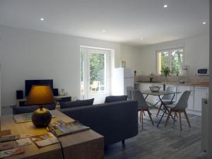 a living room with a couch and a table at Les cimes - Le gîte in Saint-Pierre-de-Rivière