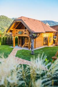 a log cabin with a gambrel roof at Village Cottage - Koča na vasi in Nazarje +19 photos