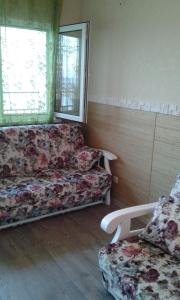 a living room with a couch and a chair at Apartment Moe More in Odesa