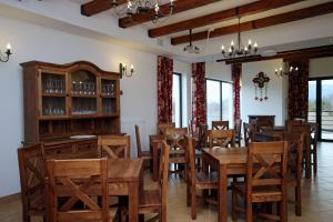 a dining room with wooden tables and chairs at Gościniec Horb in Wetlina