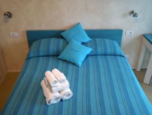 a bed with two rolled up towels on it at Bikapi in Garda