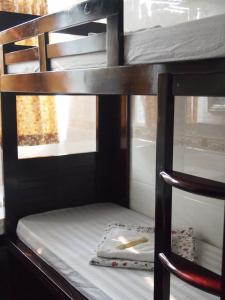 a bunk bed with a fork and a knife on it at Traveller's Hostel in Hong Kong
