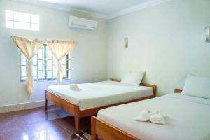 Postel nebo postele na pokoji v ubytování Visal Sak Guesthouse