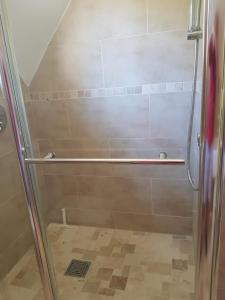 a shower with a glass door in a bathroom at Weir Cottage in Fordingbridge +34 photos