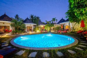 a swimming pool in front of a villa at Secret Garden Beach Resort in Bangrak Beach