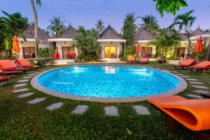 a swimming pool in front of a villa at Secret Garden Beach Resort in Bangrak Beach