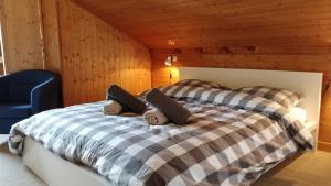 a bedroom with a bed and a blue chair at Between lake en ski resort in Thollon