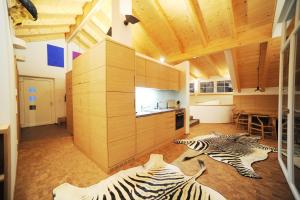 a kitchen with two zebras laying on the floor at dolomit24 | design apARTments in Sillian