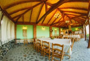 a dining room with a white table and chairs at Cabana Dintre Vii in Apoldu de Sus