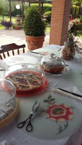 a table with plates and utensils on top of it at Casale Del Borgo in Hermada