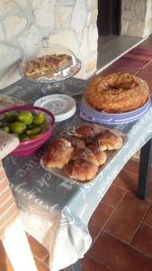 a table with pies and other food on it at Casale Del Borgo in Hermada