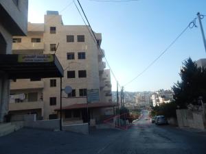 an empty street next to a tall building at Sabrina Apartments in Bethlehem