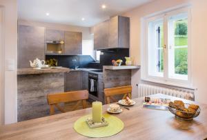 a kitchen with a wooden table with a candle on it at Villa Wilhelmine in Oberperfuss