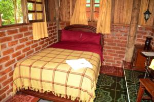 Postel nebo postele na pokoji v ubytování Hosteria Kindi Wasi