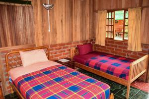 Postel nebo postele na pokoji v ubytování Hosteria Kindi Wasi
