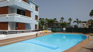 a large swimming pool in front of a building at OHMYHOST360 - Paradise Home Holidays in Playa del Ingles