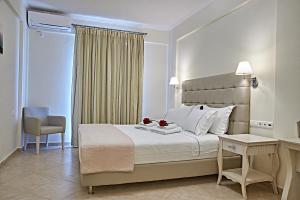 a bedroom with a bed and a desk and a chair at Element Hotel in Elafonisos