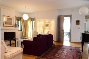 a living room with a couch and a table at La Belle Helene in Kymi