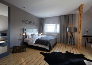 a bedroom with a large bed and a large window at LIONO BoutiqueHotel in Goslar