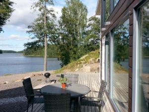 a table on a porch with a view of the water at Ammatour Villas in Uro