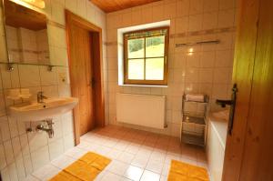 a bathroom with a sink and a toilet and a tub at Kartnall´s Alm in Neustift im Stubaital +36 photos