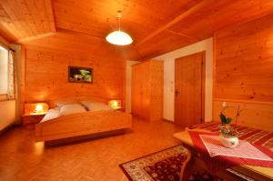 a bedroom with a bed in a wooden room at Kartnall´s Alm in Neustift im Stubaital